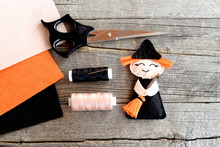 How To Sew A Halloween Witch Doll. Step. Halloween Witch Decor, Scissors, Thread, Needle, Felt Sheets On Wooden Background. Handmade Halloween Decoration For Children And Beginners. Top View