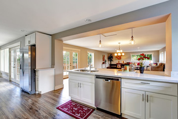 Wall Mural - Open floor plan white kitchen room with polished hardwood floor