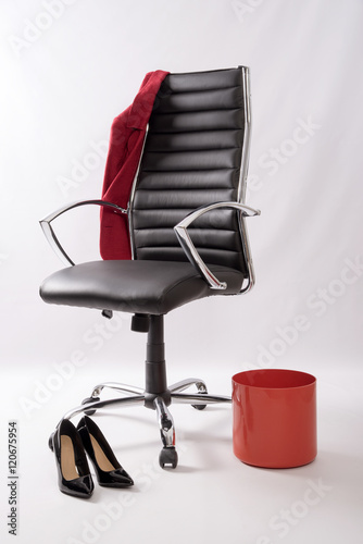 An Executive Black Leather Chair With A Red Coat Waste Bin And
