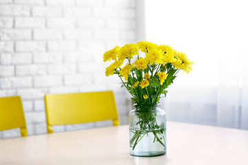 Poster - Bouquet of fresh yellow flowers on white table