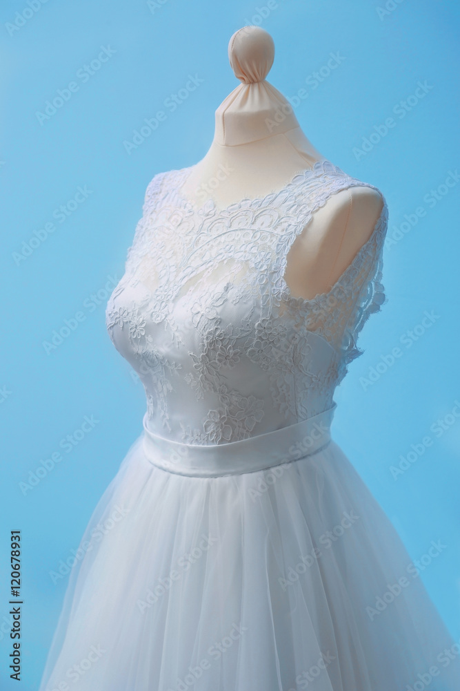 Beautiful wedding dress on wall background