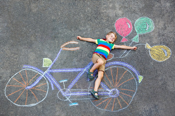 little kid boy having fun with bike chalks picture 