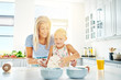 © Flamingo Images - Happy child learning to bake with her mother