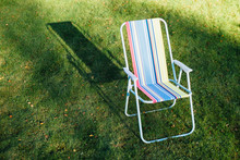 Garden Chair On Green Lawn Background
