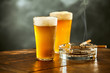 © exclusive-design - Two chilled beers with burning cigarettes