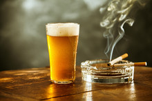 Frothy Ice Cold Beer And Cigarette In A Pub