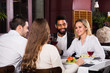 © JackF - Group of friends eating at restaurant.