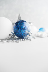 Wall Mural - blue and white xmas ornaments on glitter holiday background. merry christmas card. winter holidays. 