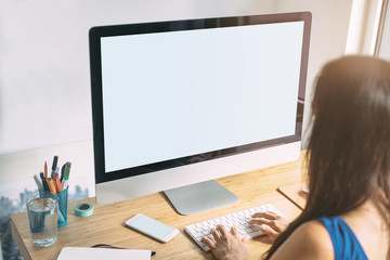 Mock-up of blank screen computer, Young girl graphic designer using modern computer while working at office, graphic designer working on new project, blurred background