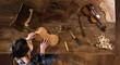 Top view. female luthier working on the creation of a violin
