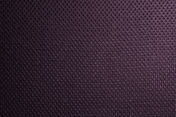 Purple fishnet cloth material as a texture background. Nylon texture pattern or nylon background for design with copy space for text or image.