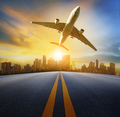 Canvas Print - road perspective to town and passenger plane flying above,air tr