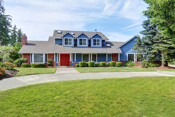 American house exterior with blue and white trim. Also red front door