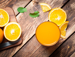 Wall Mural - fresh fruits orange juice in glass on wood,selective focus on gl