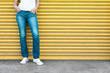 Girl posing in jeans against garage door. 
