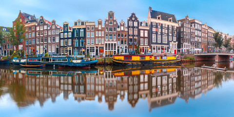 Wall Mural - Panorama of Amsterdam canal Singel with typical dutch houses and houseboats during morning blue hour, Holland, Netherlands.