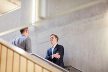 Two Businessmen Talking On Office Stairway