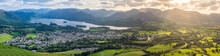 Panoramic View Of Keswick And Derwentwater With Beautiful Light Shining Through Clouds.