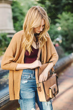 Young Woman Outdoors, Opening Satchel Style Bag