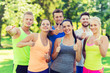 © Syda Productions - group of happy sporty friends showing thumbs up