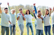 © Syda Productions - group of volunteers showing thumbs up in park