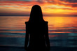 © ver0nicka - silhouette of young beautiful girl on sunset tropical beach.