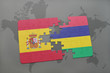 puzzle with the national flag of spain and mauritius on a world map background.