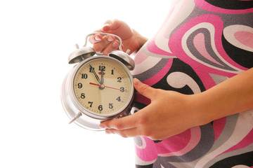 beautiful young pregnant girl on a white background with alarm c