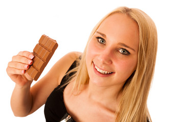 Beautiful young woman eats chocolate isolated over white backgro