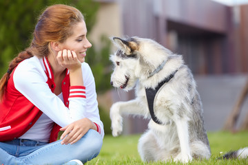 girl and dog playing outdoors