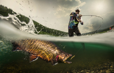 Fishing. Fisherman and trout, underwater view

