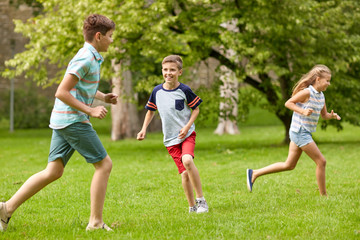 happy kids running and playing game outdoors