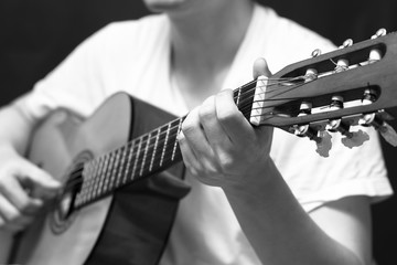 Wall Mural - male musician playing classical, acoustic guitar.  filter