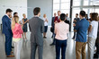 © luckybusiness - leader standing in front of his partners who applauding.