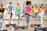 Female trainer lead group training in fitness center