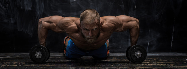 muscular bodybuilder guy over darck background