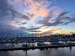 Colorful sunset over boat marina, dramatic clouds with copy space