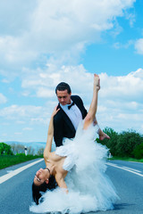 Wall Mural - wedding happy couple dancing on road