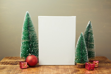 Wall Mural - Christmas holiday mock up with canvas and pine tree on wooden table