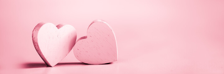 Wall Mural - two pink hearts on a pink background