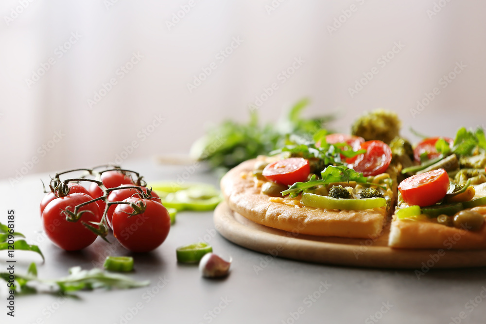 Plate with tasty vegetarian pizza on table
