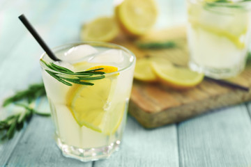 Poster - Cold fresh cocktail with lemon on wooden background