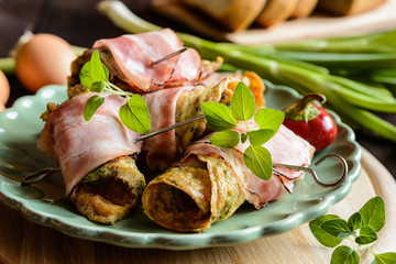 Wall Mural - Omelet rolls wrapped in smoked bacon slices