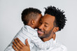 Young African American Son Hugs His Father