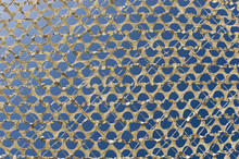 Detail Of A Beige Camouflage Grid Paper, On The Bottom Blue Sky