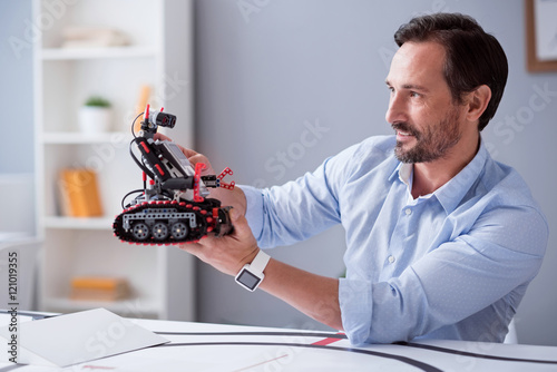 Fotografie, Obraz Happy scientist observing his robot invention