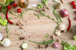 © Aleksei Ryskin - High Angle Still Life View of Knife and Wooden Cutting Board Surrounded by Fresh Herbs and Assortment of Raw Vegetables on Rustic Wood Table