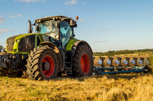 Agriculture Plowing Tractor On Wheat Cereal Fields