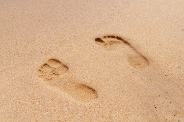 Two footprint on sandy beach