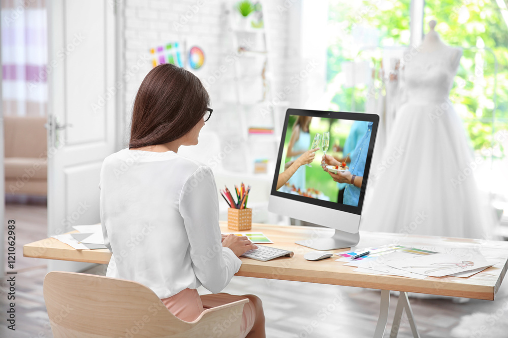 Pretty young dress designer at workplace